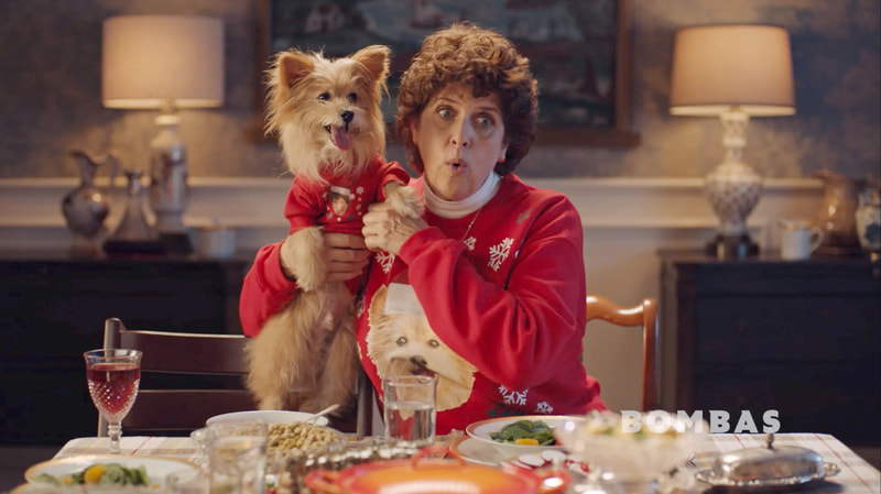 Deb with a dog in her Crazy Aunt Kathy in a Bombas Socks commercial